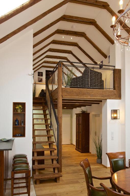 a loft conversion with a spiral staircase in a room at Hochgrat in Oberstaufen
