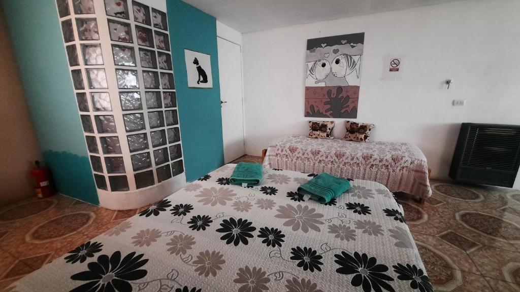 um quarto com duas camas e um quadro na parede em Moni Moni P A em Río Gallegos