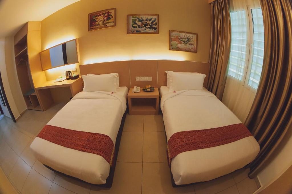 Postel nebo postele na pokoji v ubytování Paragon Lutong Hotel