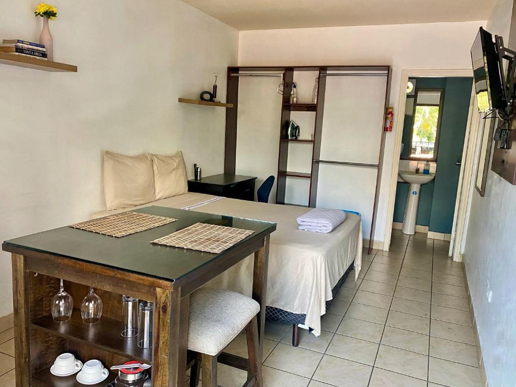 a small room with a bed and a table at Suite Noa Apartamento in San Pedro Sula