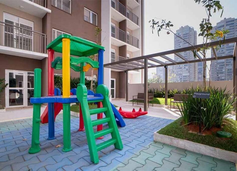 a playground in the courtyard of a apartment building at Studio Lupi in Sao Paulo