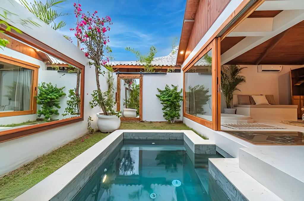 an indoor swimming pool in the backyard of a house at BaraJade Villas in Uluwatu