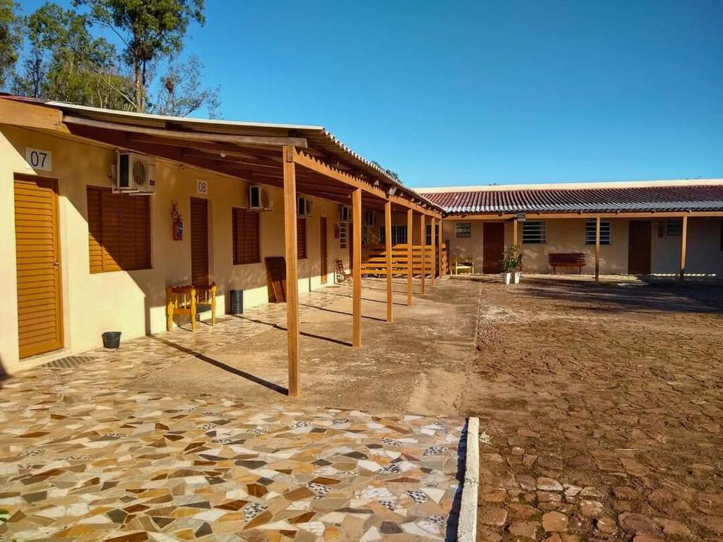 a building with a row of posts next to a courtyard at Hotel Alvorada in Alegrete