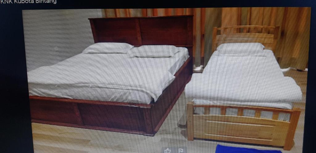 Postel nebo postele na pokoji v ubytování Homestay KNK