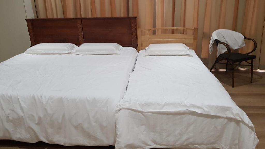 Postel nebo postele na pokoji v ubytování Homestay KNK