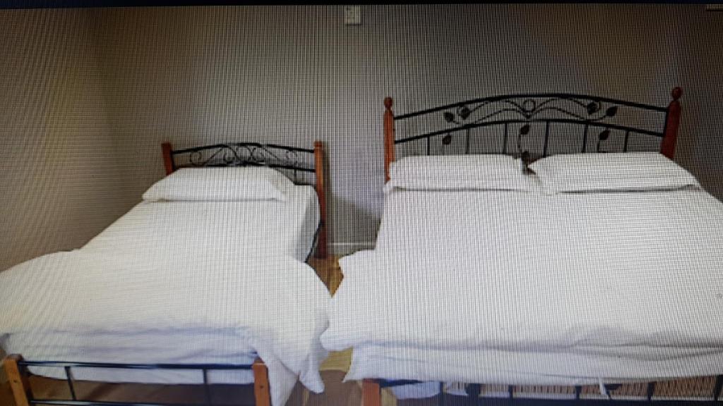 Postel nebo postele na pokoji v ubytování Homestay KNK