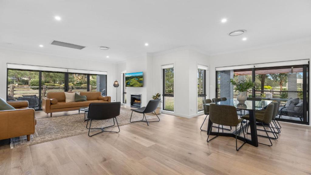 a living room with a couch and a table and chairs at Greenview in Pokolbin