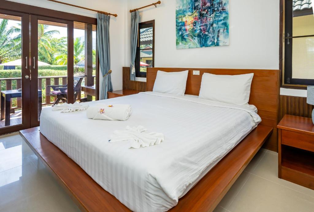 Postel nebo postele na pokoji v ubytování Phatcharee Resort