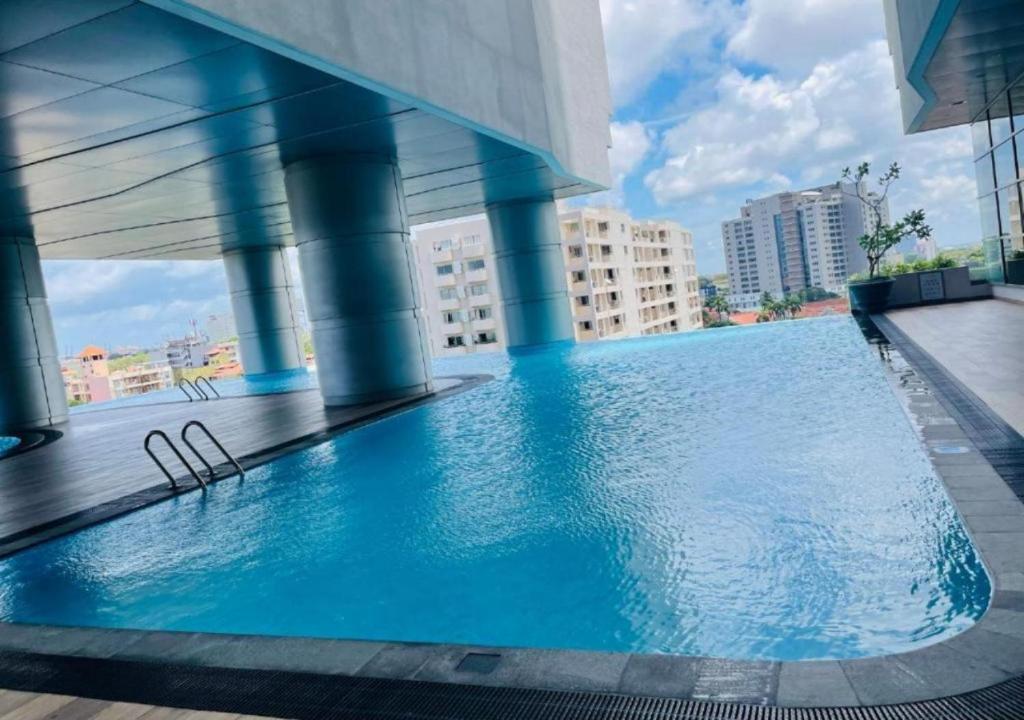 a large swimming pool on the roof of a building at The Grand ward place super luxury 2 bedroom apartment Colombo 7 in Colombo
