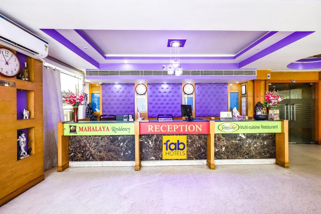 a reception desk in an office with a reception counter at FabHotel Prime Mahalaya Residency in Chennai