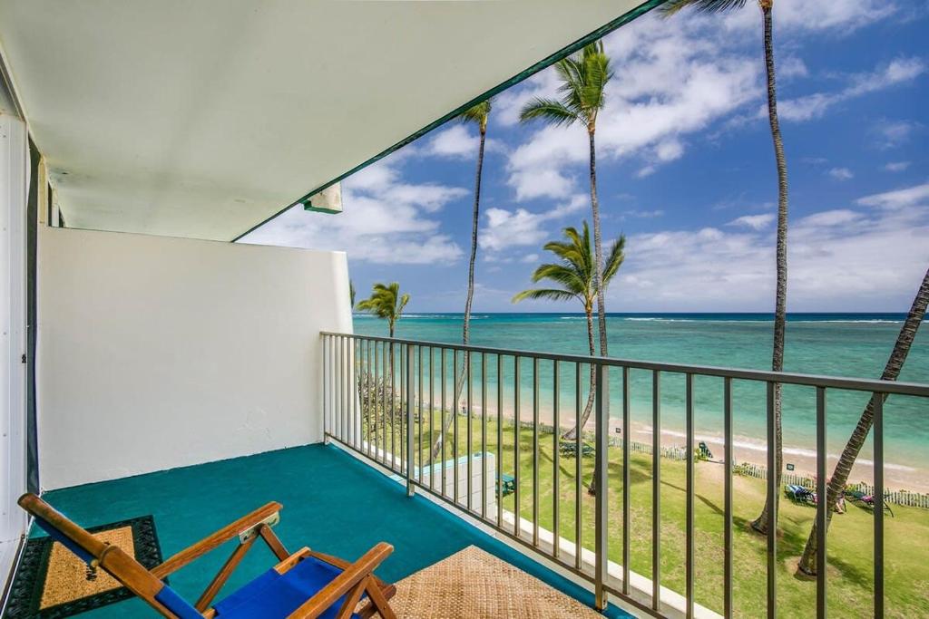 a balcony with a view of the beach at Luxury Beachfront with Breathtaking views & AC in Hauula