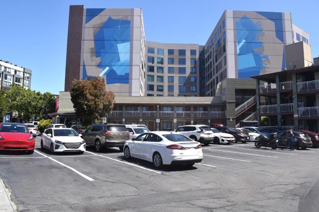 a parking lot with cars parked in front of buildings at SF Central Hotel in San Francisco