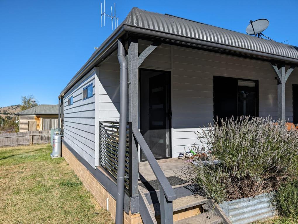 a tiny house with a porch and a deck at Snow-Berri in Berridale