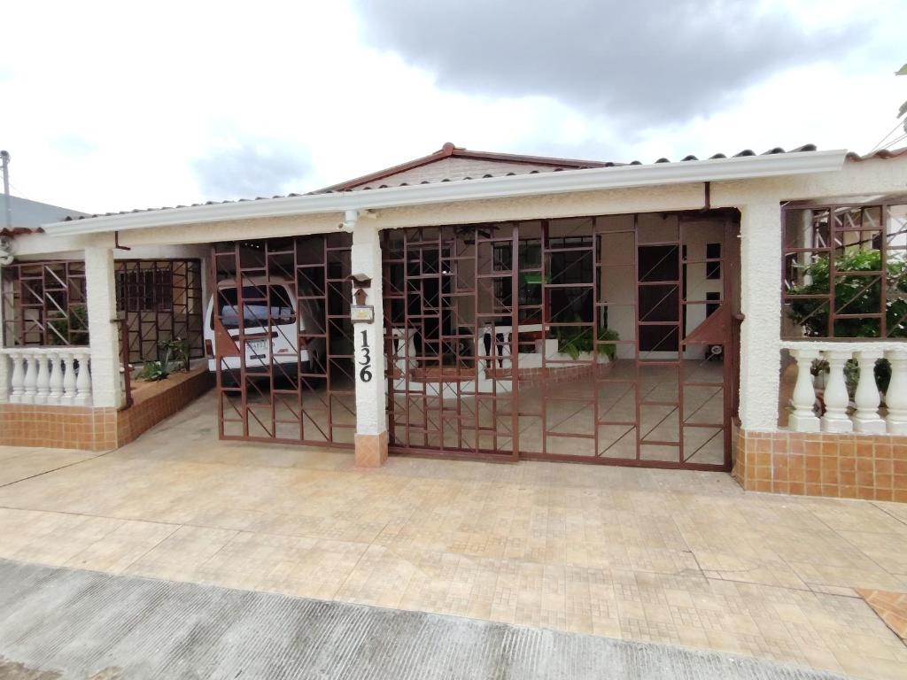 a house with a garage with a gate at Casa con piscina, 1 cuarto barato in ArraijÃ¡n