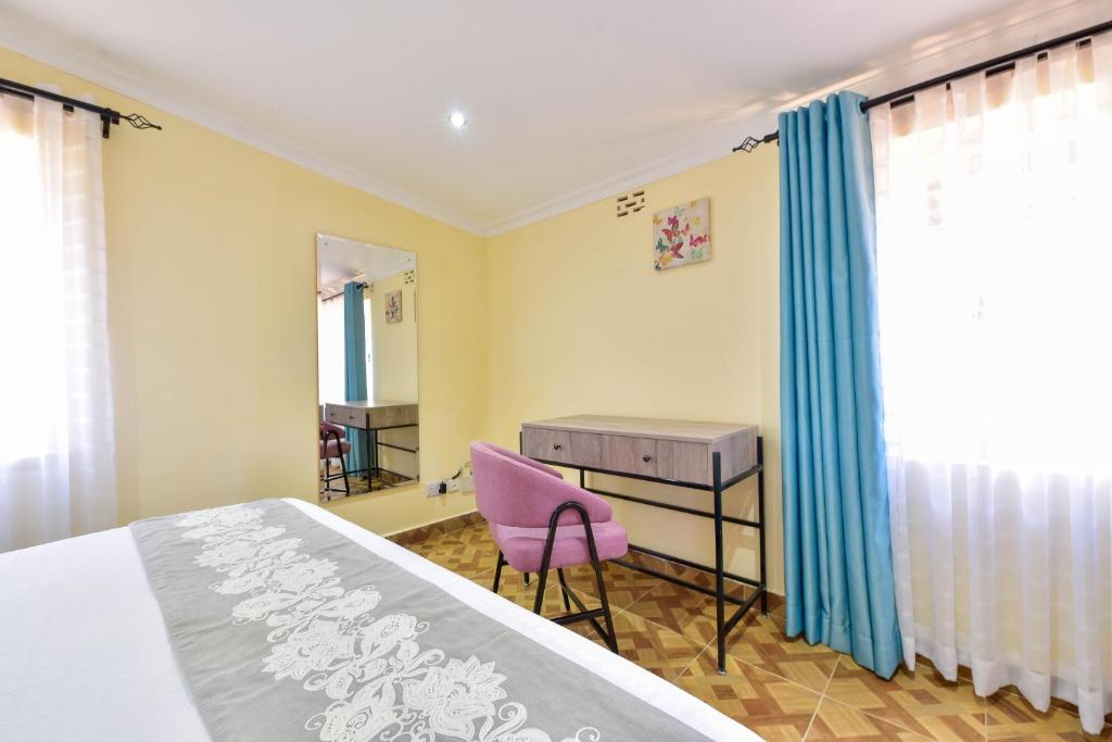 Postel nebo postele na pokoji v ubytování Kongoni House