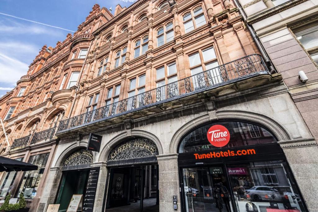 a building with a balcony on the side of it at Tune Hotel Liverpool in Liverpool