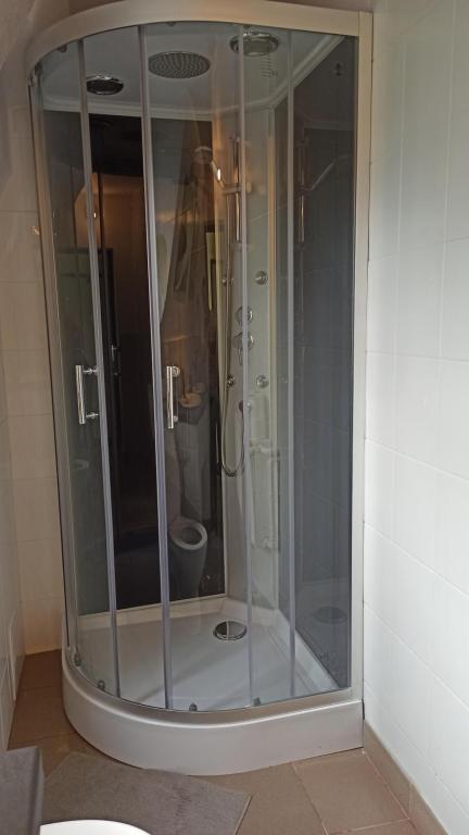 a glass shower in a bathroom with a toilet at Willa Retro Hostel in Krakow