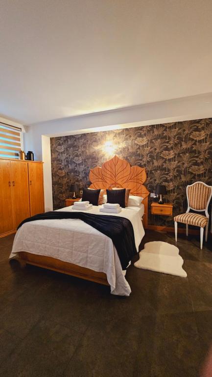 a large bedroom with a large bed and a wall at Paloma entorno natural in Oiartzun