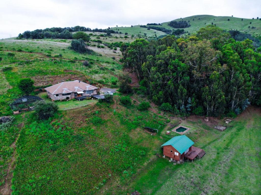 an aerial view of a house in a field at Incwala Lodge in Waterval Boven