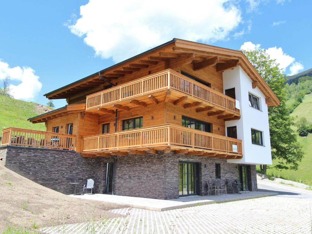 a large house with a balcony on top of it at Modern chalet with sauna near ski area in Saalbach Hinterglemm Salzburgerland in Saalbach-Hinterglemm