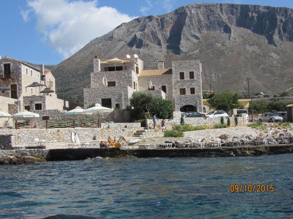 a group of buildings with a mountain in the background at Kyrimi in Gerolimenas