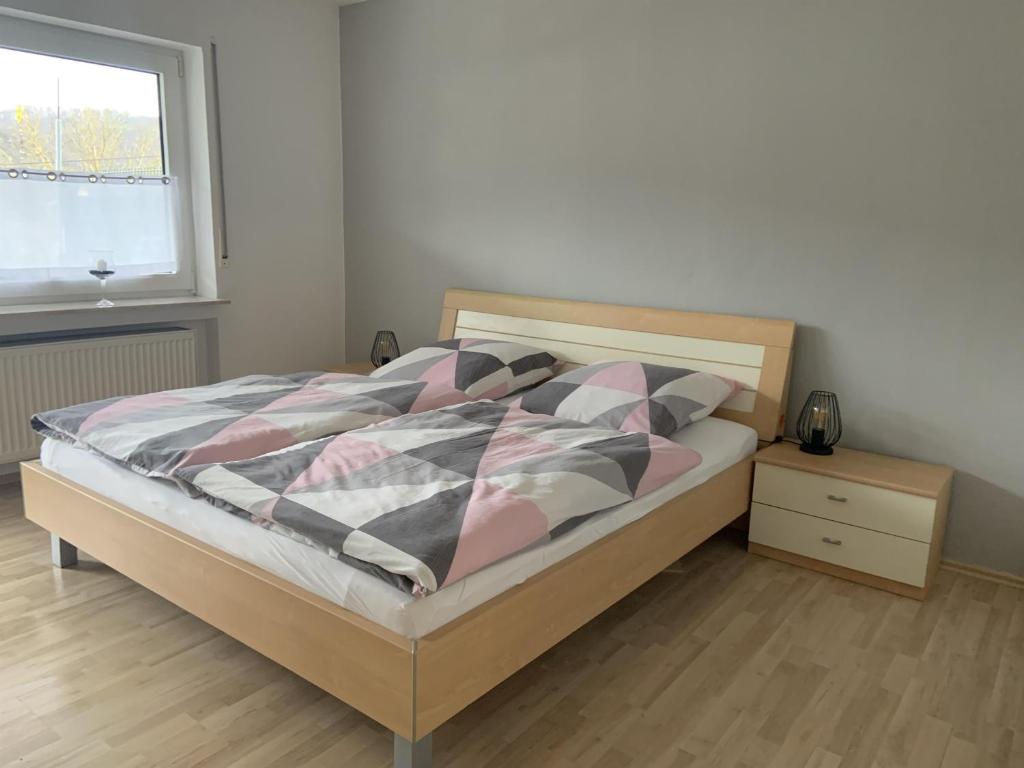 a bedroom with a bed and a window at Ferienwohnung Dieblich in Dieblich