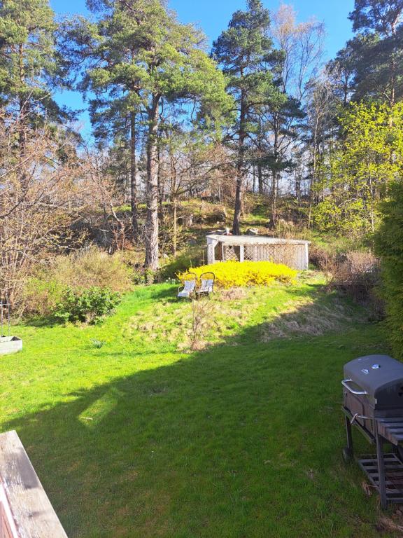 a lawn with two picnic tables in a park at Room in Bromma, Stockholm in Stockholm
