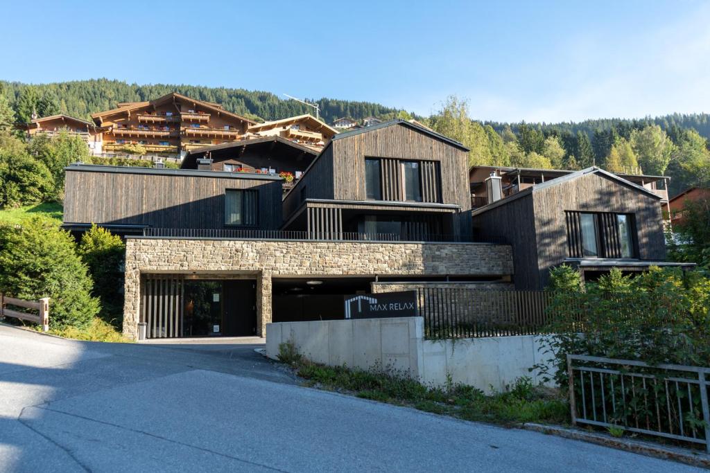 a house on a hill with a driveway at Max Relax, Ski in - ski out in Zell am See