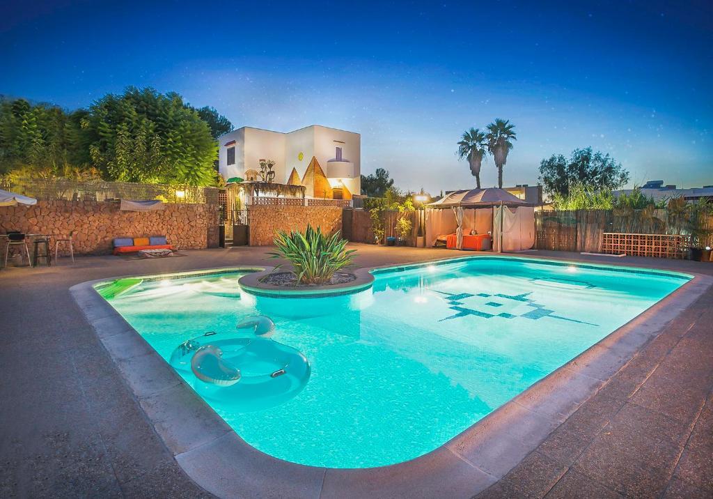 - une grande piscine dans une cour la nuit dans l'établissement Villa Walk To O Beach Large Pool Bbq, à Sant Antoni de Portmany