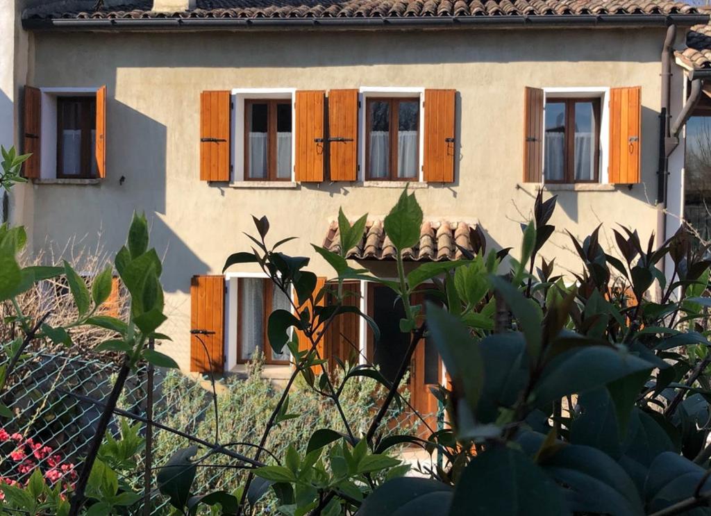 een huis met bruine luiken en een hek bij Tre Grazie - Quando il viaggio offre l'esperienza in Possagno