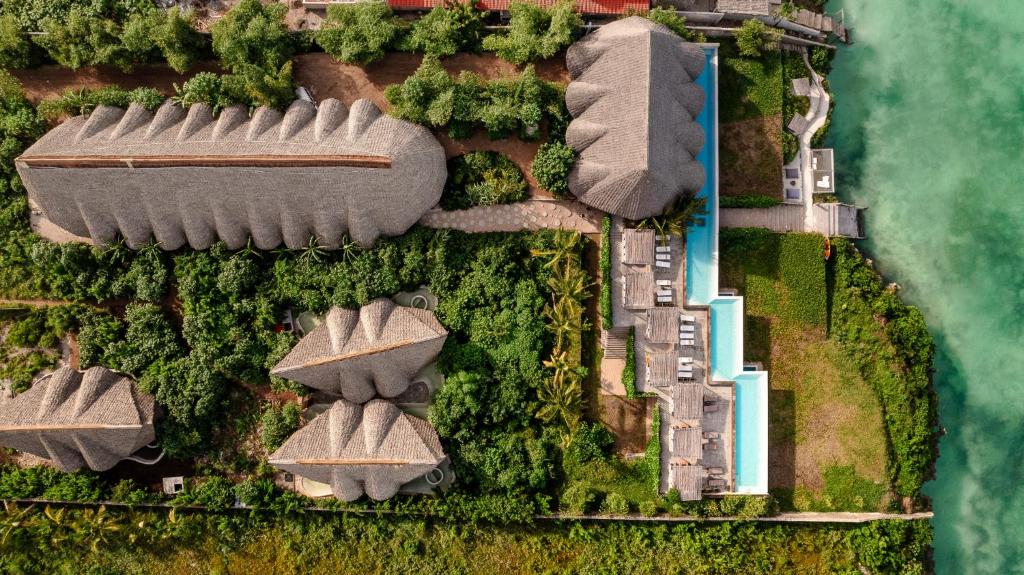 an overhead view of roofs of buildings next to the water at Bamboo Zanzibar in Jambiani