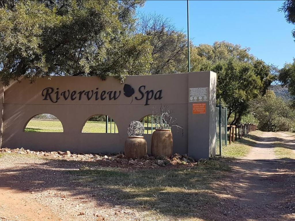 a sign for the riberiber spa in a field at Riverview Spa Bed and Breakfast in Lanseria