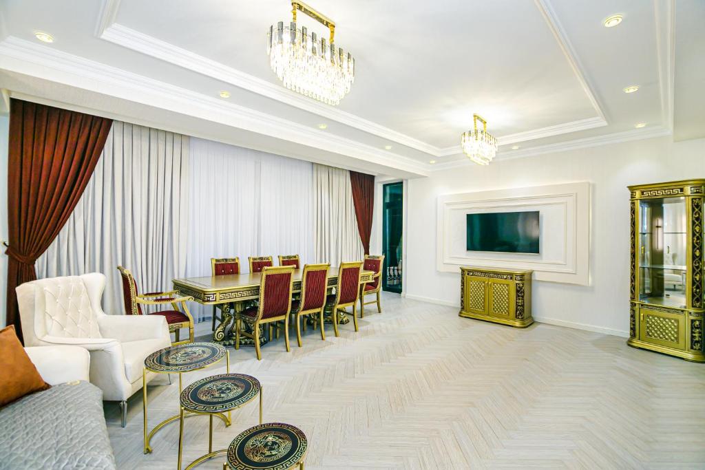 a living room with a table and a dining room at Deluxe Apartment 15/1 in Baku