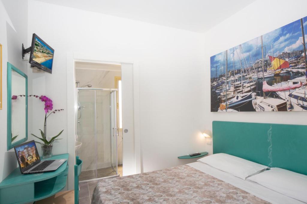 Postel nebo postele na pokoji v ubytování Hotel Marselli