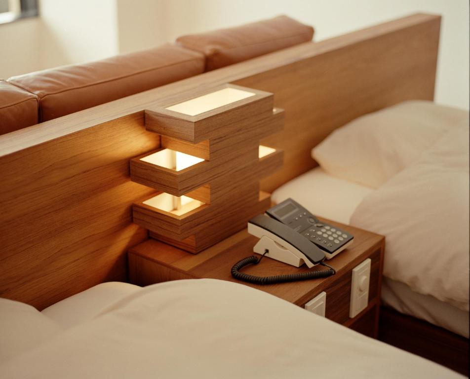 Postel nebo postele na pokoji v ubytování Kameya Hotel