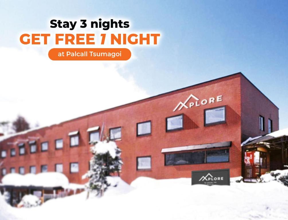 a building with a sign that says stay nights get free night at Xplore by Active Life in Iiyama