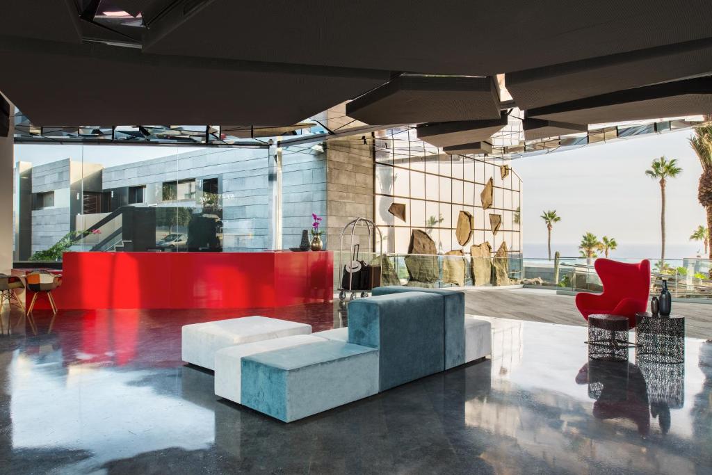 a lobby of a building with a couch and chairs at La Isla y el Mar, Hotel Boutique in Puerto del Carmen
