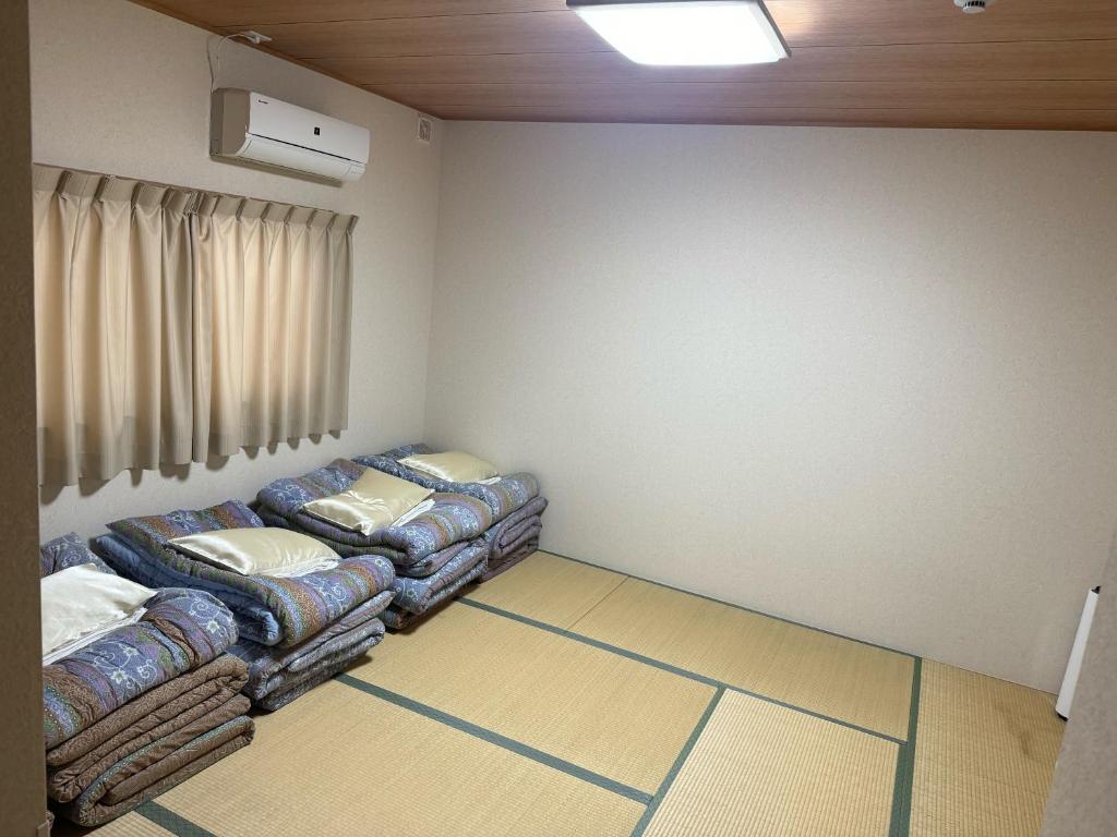 Postel nebo postele na pokoji v ubytování GATE80長居