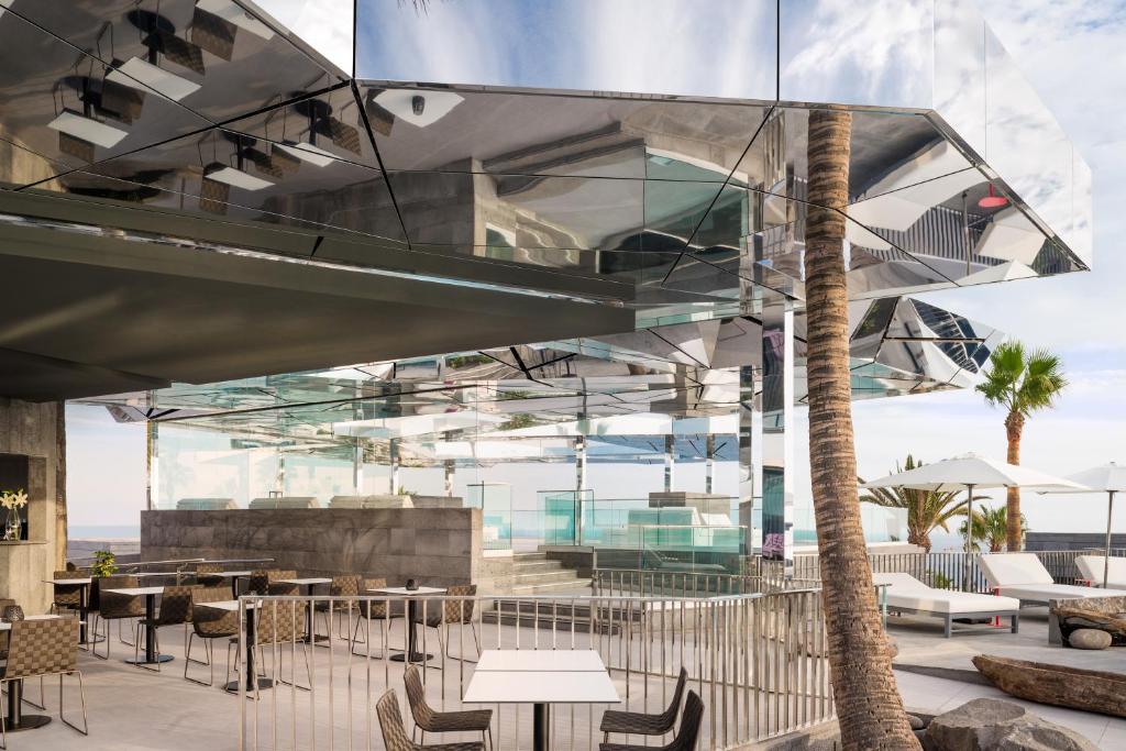 a restaurant with glass ceilings and tables and chairs at La Isla y el Mar, Hotel Boutique in Puerto del Carmen