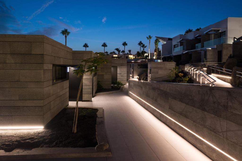 a building with lights on the side of it at La Isla y el Mar, Hotel Boutique in Puerto del Carmen