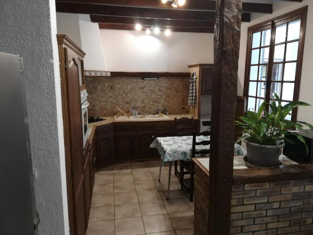 a kitchen with a sink and a table at L&#39;éveil in Vittefleur