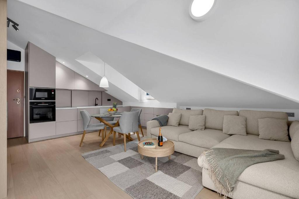 a living room with a couch and a table at Penthouse Nikolina-50m to beach! - Makarska Exklusiv in Makarska