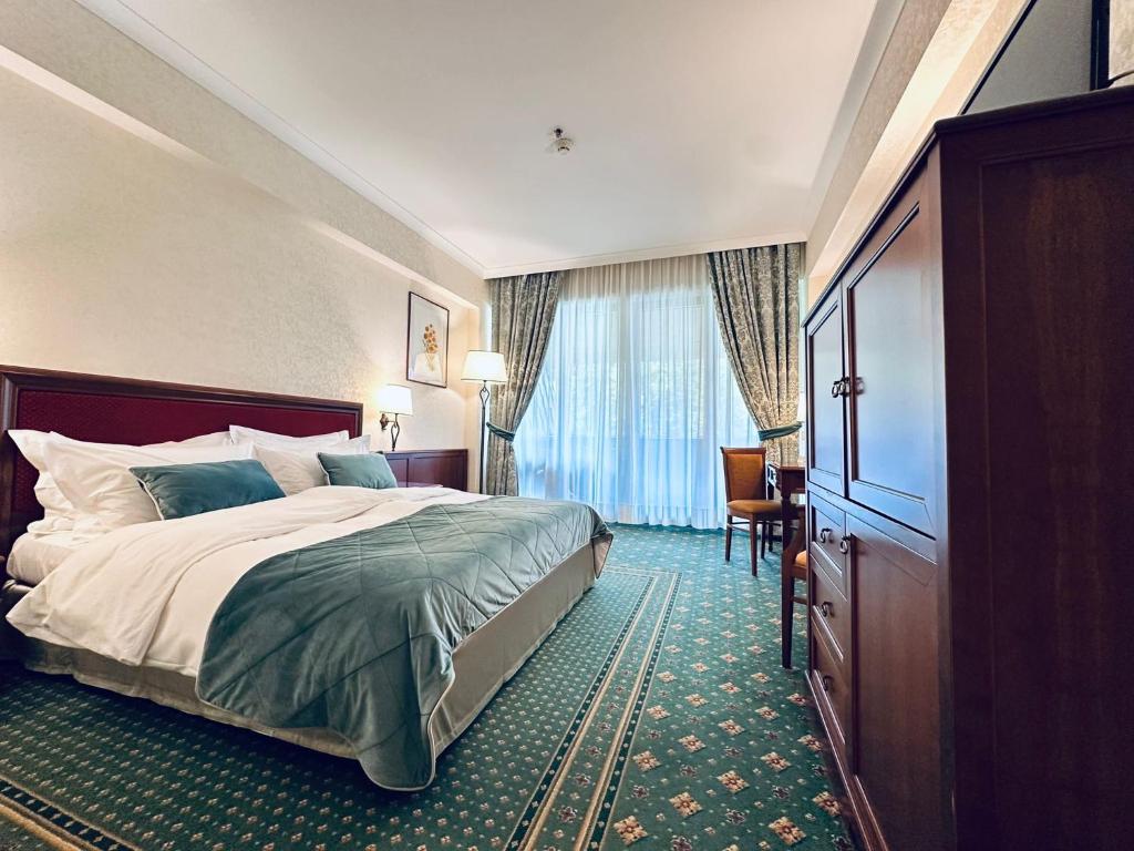 Postel nebo postele na pokoji v ubytování Lux Garden Hotel