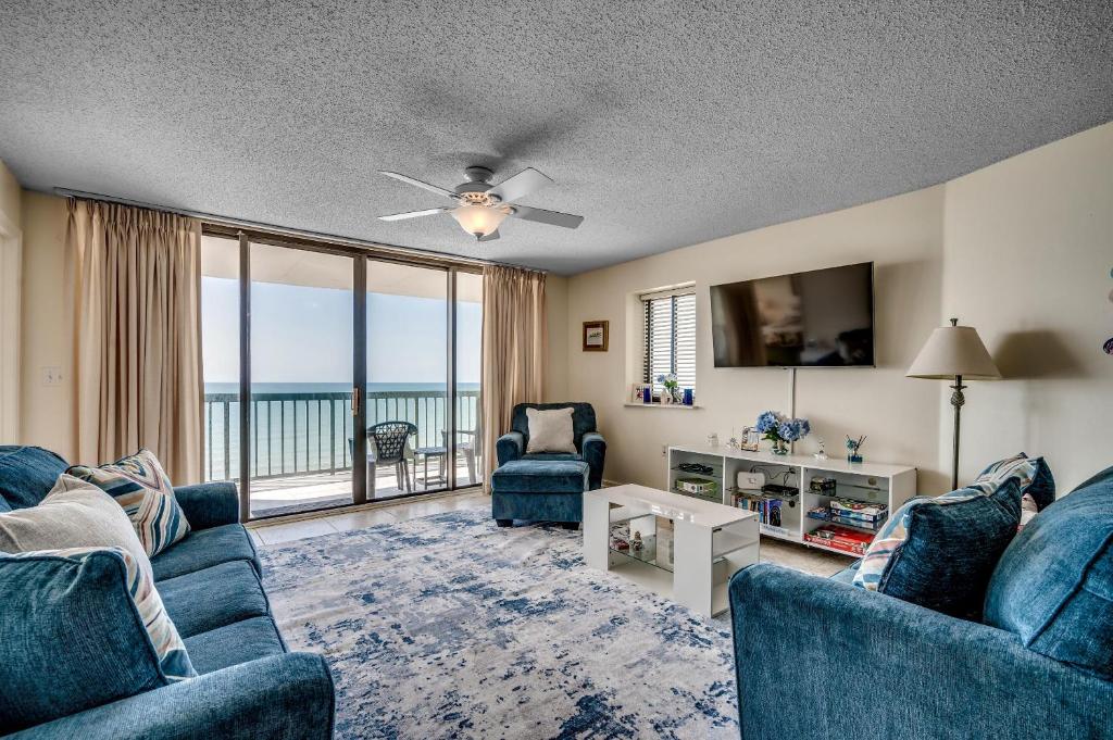 a living room with blue furniture and a view of the ocean at Ocean Bay Club 1201 in Myrtle Beach