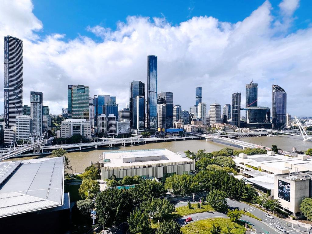 a view of a city with a river and buildings at Riverview Haven Prime Spot for NY Fireworks in Brisbane
