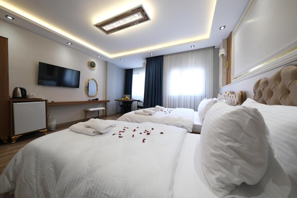 Postel nebo postele na pokoji v ubytování Elita Otel Kumkapı