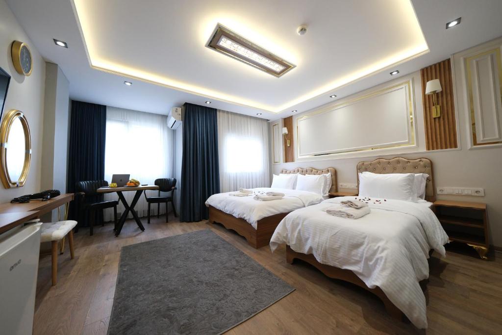 Postel nebo postele na pokoji v ubytování Elita Otel Kumkapı