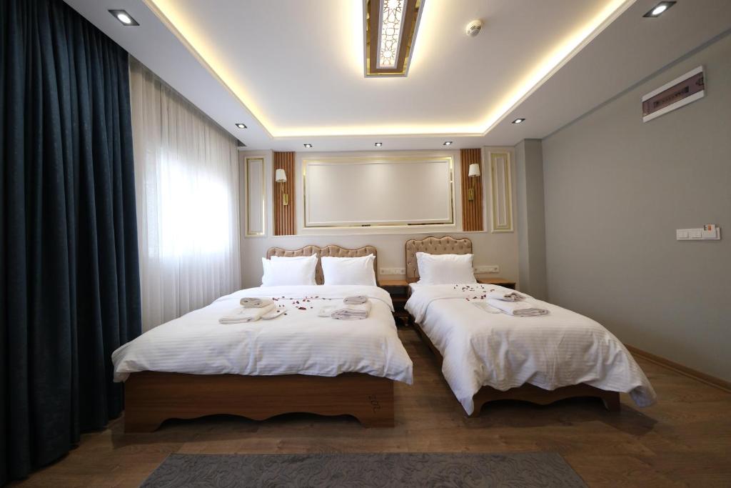 Postel nebo postele na pokoji v ubytování Elita Otel Kumkapı