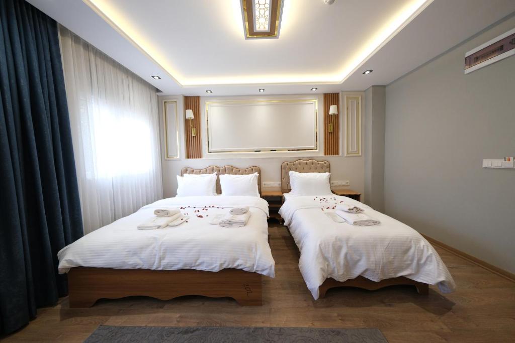 Postel nebo postele na pokoji v ubytování Elita Otel Kumkapı