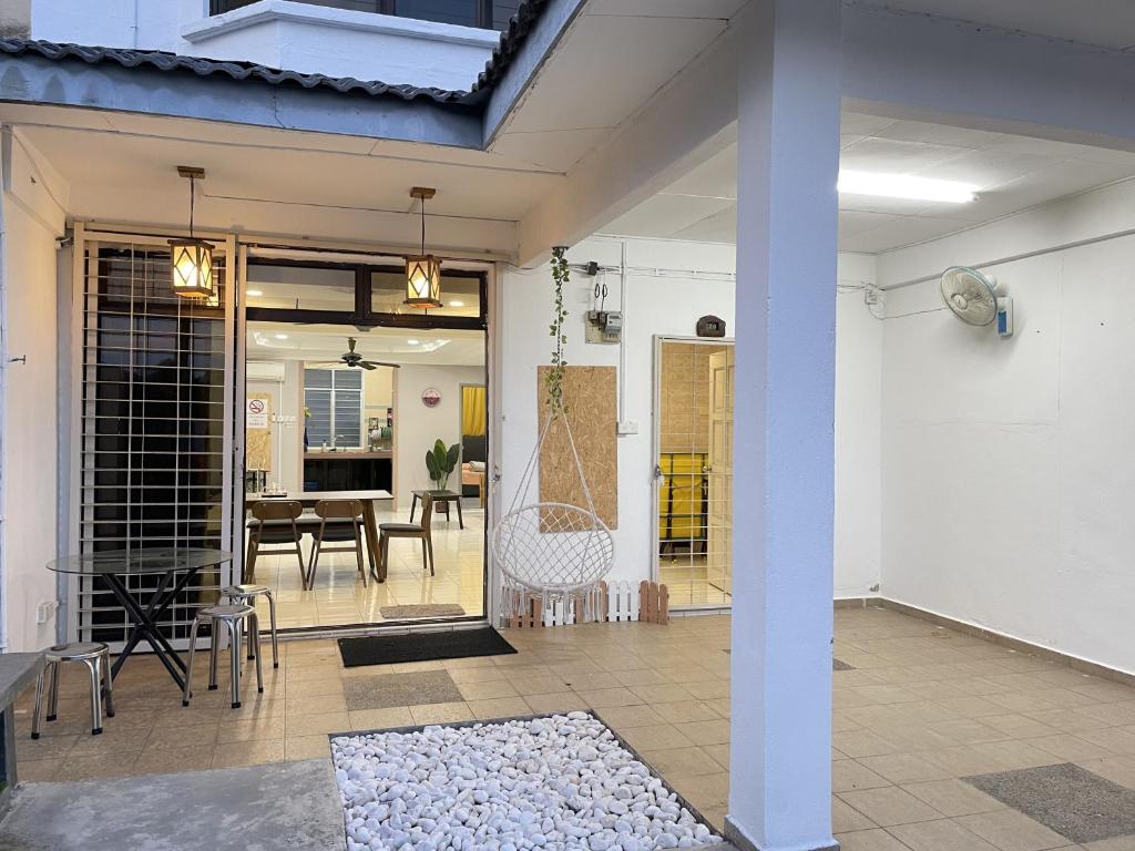 a patio with a table and a dining room at 8min Port Dickson beach 17pax Pet Friendly in Port Dickson